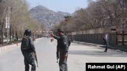 AFGHANISTAN -- Police patrol the streets after a suicide attack in front of the Kabul university in Kabul, Wednesday, March 21, 2018.