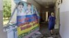 UKRAINE – A woman walks around a damaged school for visually impaired children, following a Russian rocket strike on Kharkiv, 07 July 2022