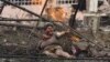 A wounded Georgian woman lies with other people in front of an apartment building hit by a Russian air strike in the northern Georgian town of Gori on August 9, 2008.