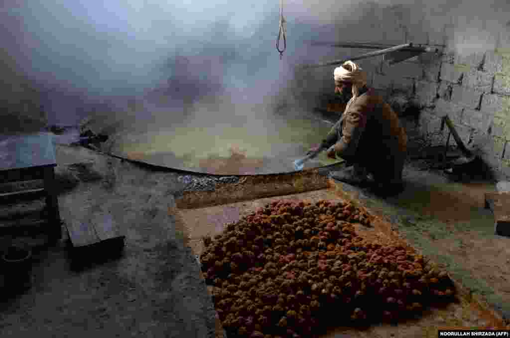 An Afghan laborer prepares brown sugar from sugarcane juice at a traditional factory in the Kama District of Nangarhar Province, east of Jalalabad. (AFP/Noorullah Shirzada)