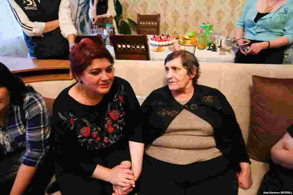 Khadija sits with her mother, Elmira.