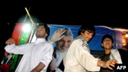 Supporters of Afghan President Hamid Karzai dance in Herat following the declaration his election victory on November 2.