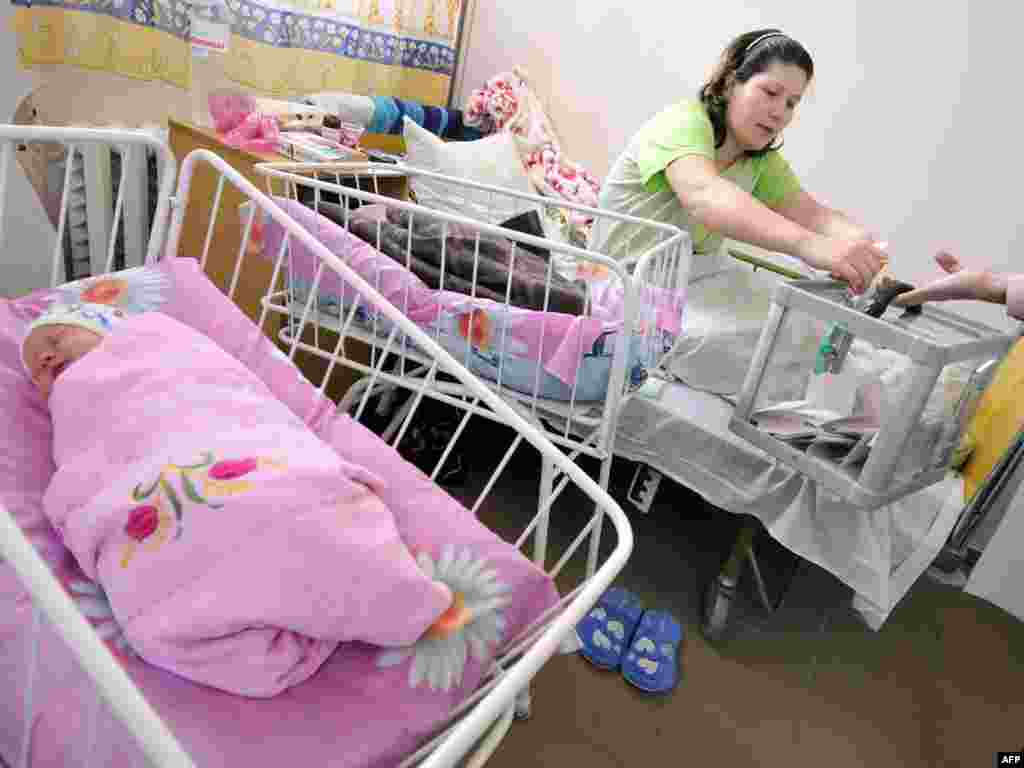 The mother of a newborn casts her ballot for president at a maternity hospital in the western Ukrainian city of Lviv.