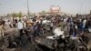 Iraqi security forces and onlookers gather at the site of a car bomb attack in Baghdad's mainly Shi'ite district of Sadr City on May 17.