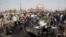 Iraqi security forces and onlookers gather at the site of a car bomb attack in Baghdad's mainly Shi'ite district of Sadr City on May 17.