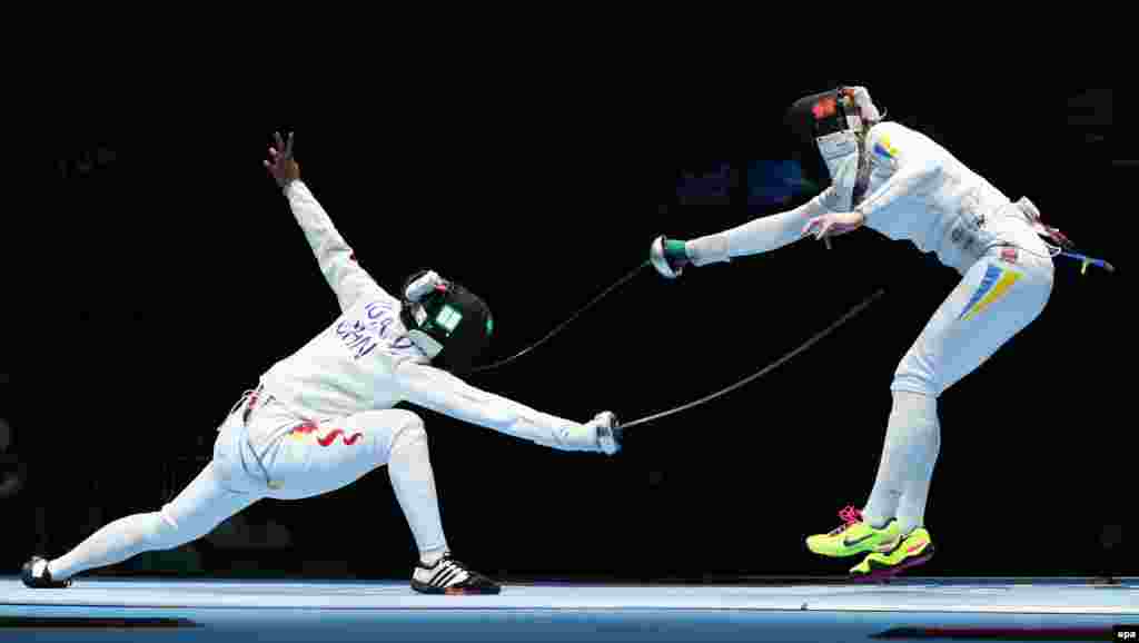 Anqi Xu of China battles Ukraine's Olena Kryvytska (R) in a women's epee team quarterfinal match.