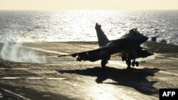 A French warplane lands aboard the Charles de Gaulle aircraft carrier during a 2015 mission.