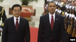 U.S. President Barack Obama (right) walks with Chinese President Hu Jintao during a welcoming ceremony at the Great Hall of the People in Beijing, November 2009.