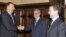 Russia's Dmitry Medvedev (right) looks on as Armenia's Serzh Sarkisian (center) and Azerbaijan's Ilham Aliyev shake hands in Moscow.