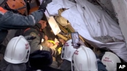 An 11-month-old baby is saved from the rubble of the collapsed building in Magnitigorsk.