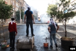 Protesters clash with riot police during a demonstration against Islamic State in Diyarbakir in southeastern Turkey on October 7.