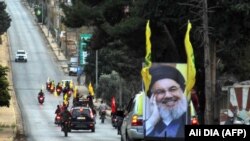 Lebanon -- Supporters of the Shiite Hezbollah movement drive in a convoy in support of its leader Hassan Nasrallah's speech, in the area of Fatima's Gate in Kfar Kila on the Lebanese border with Israel on October 25, 2019. - Tensions rattled Lebanon's nin