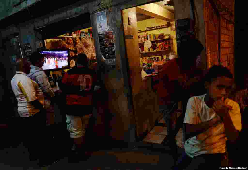 Residents of the Mangueira favela in Rio de Janeiro, Brazil, watch the opening ceremony of the 2016 Summer Olympics on August 5. (Reuters/Ricardo Moraes)