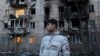 A resident stands next to an apartment building damaged in a Russian drone attack in Odesa on January 17.