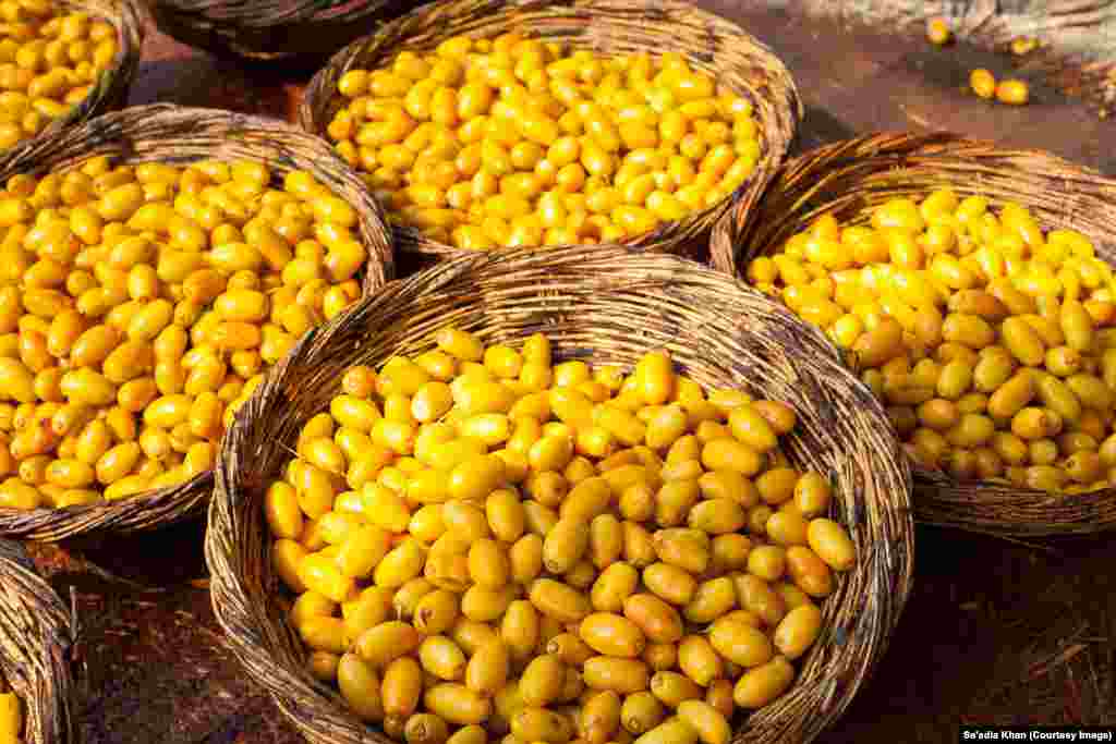 Baskets full of dates to be cooked in a giant wok, fueled by firewood to an optimum temperature for the process.