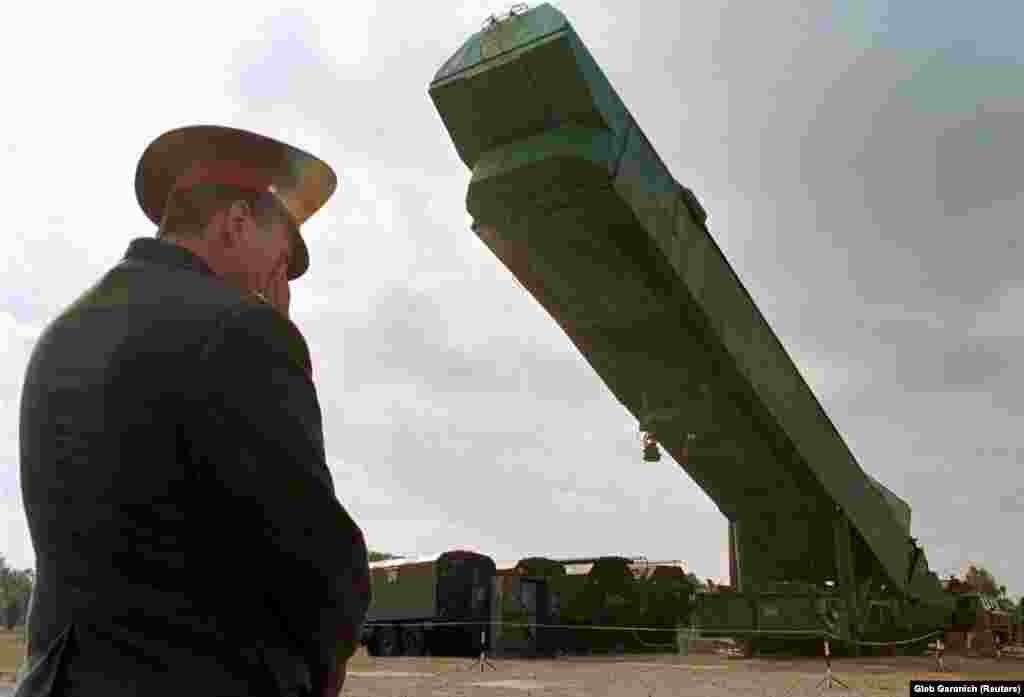 An Ukrainian officer watches a SS-24 nuclear missile booster being removed from its bunker at a military base in southern Ukrainian town of Pervomaysk on September 29, 1998.