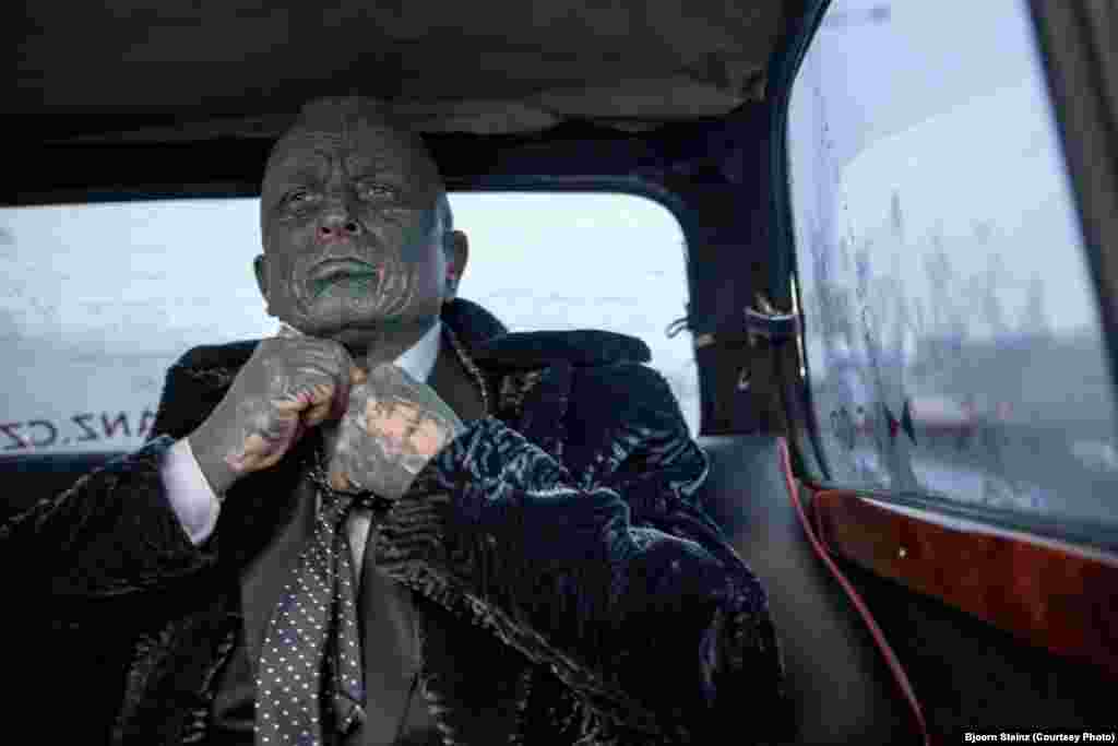 Vladimir Franz, a candidate for the Czech presidency, corrects his tie while riding in "Air Franz One," his official campaign car, in Prague. Franz is a prominent Czech composer, painter, and professor who is also a registered candidate in the 2013 Czech presidential election on January 11-12. He is a polling a surprising third in opinion surveys.