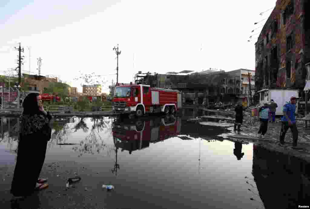 A woman looks at the site of a car-bomb attack in Baghdad. (Reuters/Ahmed Saad)