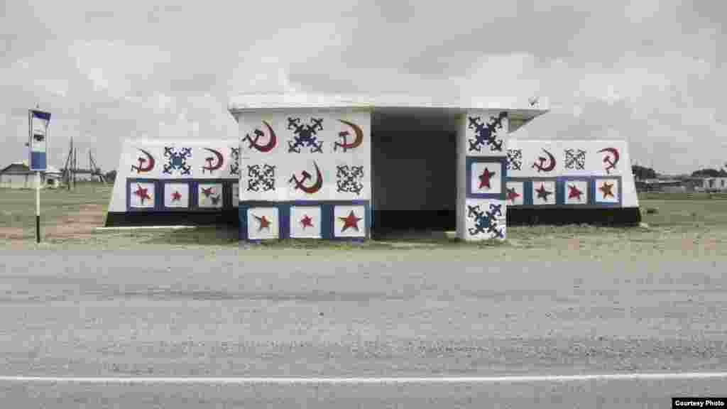 A bus stop in Kazakhstan&#39;s Akmola region -- one of only a few decorated with Soviet propaganda elements. The outdated symbols had been recently refreshed with a new coat of paint. 