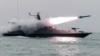 Undated file photo released by Iran's Revolutionary Guards Corps (IRGC) shows a boat firing a missile during a military exercise in the Gulf.