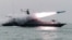 Undated file photo released by Iran's Revolutionary Guards Corps (IRGC) shows a boat firing a missile during a military exercise in the Gulf.