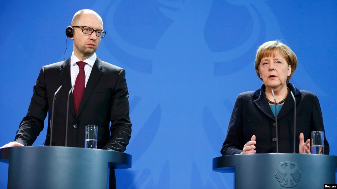 Ukrainian Prime Minister Arseniy Yatsenyuk and German Chancellor Angela Merkel address a news conference following talks at the Chancellery in Berlin on January 8.