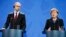 Ukrainian Prime Minister Arseniy Yatsenyuk and German Chancellor Angela Merkel address a news conference following talks at the Chancellery in Berlin on January 8.