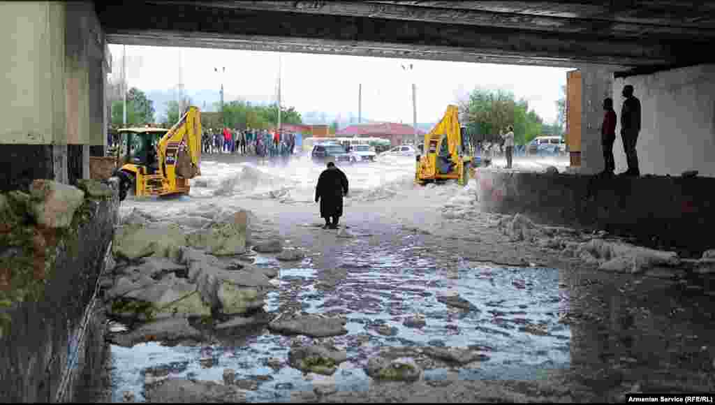 Clumps of ice under a railway bridge in Gyumri on July 14 &nbsp; As the cleanup continued and local authorities counted the cost of the damage, Naira Grigorian said on July 15 that chunks of ice remained on the streets in some parts of the city -- despite balmy temperatures of 28 degrees Celsius.