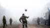 Ukrainian servicemen play football on a road near Debaltseve on February 15 shortly after a cease-fire began to be cautiously observed by both pro-Russian rebels and Kyiv forces in the country&#39;s months-long conflict. (AFP/Volodomyr Shuvayev)