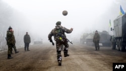 Ukrainian servicemen play soccer on a road at Svitlodarsk, approaching Debaltseve on February 15, hours after a cease-fire came into effect. The truce seems to have been cautiously observed by both sides, despite accusations by Kyiv and Washington that Russia had fueled a final push by rebels to gain territory before the start of the cease-fire.