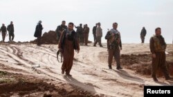 Kurdish Peshmerga fighters during a battle against Islamic State militants on the outskirts of Mosul on January 21.