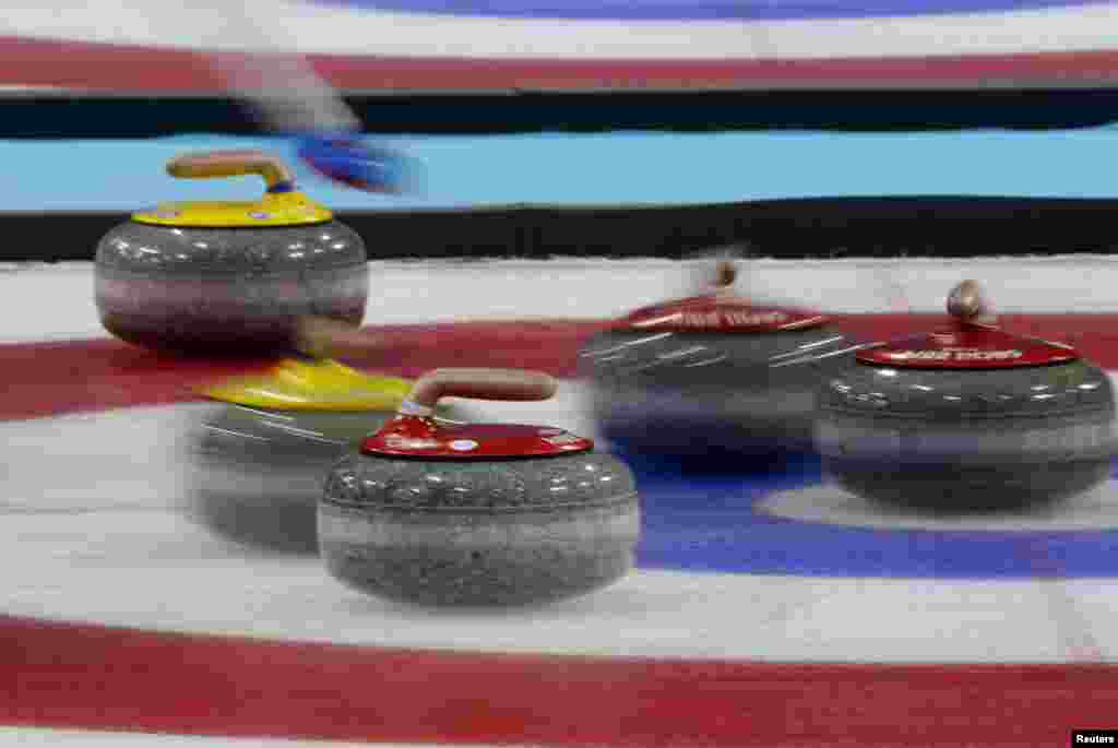 Red stones played by Canada and yellow ones played by Britain are seen in the house during their men's curling gold-medal game. Canada won. (Reuters/Laszlo Balogh)
