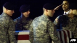 U.S. President Barack Obama salutes as U.S. Army soldiers carry the coffin of Sergeant Dale Griffin.