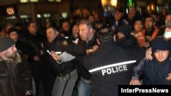 Opposition supporters clash with riot police in Tbilisi on April 23.