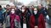 Iranian women wearing protective masks to prevent contracting coronavirus walk at Grand Bazaar in Tehran, February 20, 2020