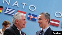 U.S. Secretary of State Rex Tillerson (left) greets NATO Secretary-General Jens Stoltenberg during the alliance's foreign ministers meeting in Brussels on March 31. 