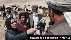 Afghanistan -- Azadi Radio reporter speaks with the people at the animal market in Kabul in November, 2011.