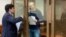 Vladimir Kara-Murza (right) talks to his lawyer, Vadim Prokhorov, during a preliminary court hearing in Moscow on March 6.