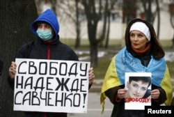 People take part in a protest in front of the Russian Embassy in Minsk on March 21 demanding the liberation of Ukrainian pilot Nadia Savchenko by Russia.