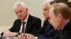 Gennady Timchenko (left) attends a meeting with Russian President Vladimir Putin (right) and a delegation of French businessmen in Moscow in 2016. The oil-trading tycoon is expected to be included on an upcoming list of U.S. sanctions. (file photo)