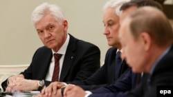 Gennady Timchenko (left) attends a meeting with Russian President Vladimir Putin (right) and a delegation of French businessmen in Moscow in 2016. The oil-trading tycoon is expected to be included on an upcoming list of U.S. sanctions. (file photo)