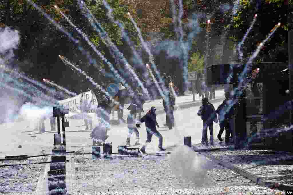 Demonstrators clash with riot police outside a university in Ankara during protests denouncing Turkey's unwillingness to intervene militarily against Islamic State forces in the Syrian town of Kobani. (AFP/Adem Altan)