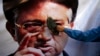 A Pakistani man places a shoe on an image of former President Pervez Musharraf during a protest in Quetta last month. 