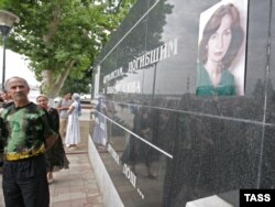 Фотография активистки "Мемориала" Натальи Эстемировой на мемориальной плите в честь журналистов, погибших за свободу сллова. Грозный, 17 июля 2009 года.