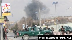 Afghan security forces guard the area as smoke billows from the Sardar Daud Khan hospital, also known as the Kabul Military Hospital, during an attack by suspected militants in Kabul on March 8.