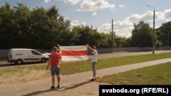 Бел-чырвона-белымі сьцягамі сустракалі кіроўцаў удзельнікі пікету