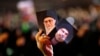 A Hezbollah supporter holds up portraits of Hezbollah leader Hassan Nasrallah and Iranian supreme leader Ayatollah Ali Khamenei in Beirut. File photo