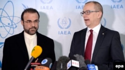 Iranian Ambassador to the IAEA Reza Najafi (left) and Tero Varjoranta, IAEA deputy director general and head of the Department of Safeguards, talk to journalists prior to a meeting in Vienna on December 11.