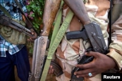 An armed fighter belonging to the 3R rebel group displays his weapon in the town of Koui in the Central African Republic in 2017. The country has been riddled by violence since a 2013 rebellion overthrew then-President Francois Bozize.