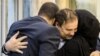 Iranian doctor Majid Taheri, who had been detained in the United States for 16 months, hugs his children upon his arrival at Tehran's Imam Khomeini International Airport on June 8, 2020.